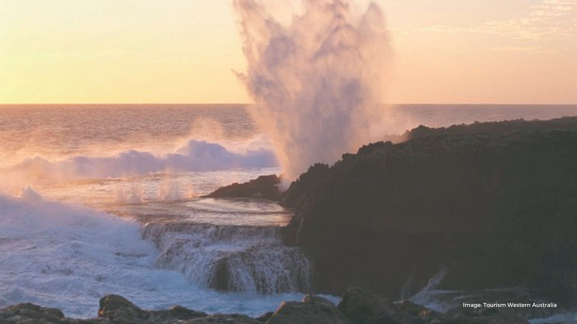 Ocean waves blow hole on rocky edge at sunset | Tourism Western Australia