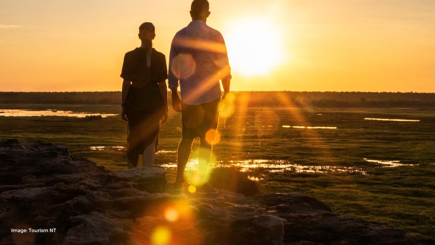 Couple standing looking at sunset at Ubirr | Tourism NT