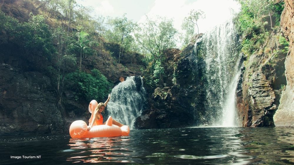 Girl sitting on floating at waterfall | Tourism NT