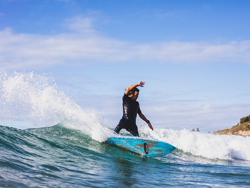Surfer at Turners Beach, Yamba, New South Wales. Image Credit: Destination NSW