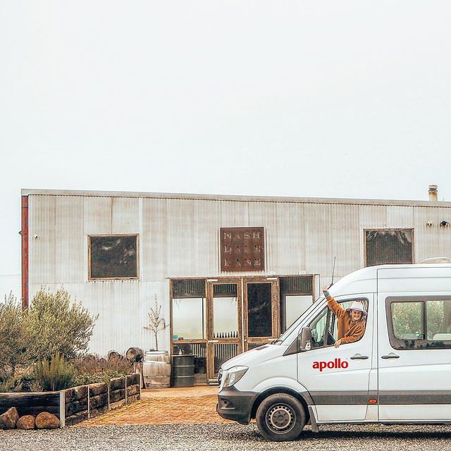 Apollo campervan parked out the front of old rustic building