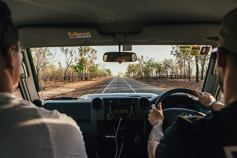 Looking out onto a Northern Territory road from the drivers cabin of a 4WD