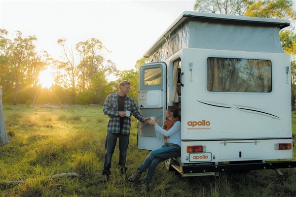 Couple drinking coffee in Apollo Adventure Camper
